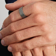 close up on a man's hand with a maze champlevé ring pattern